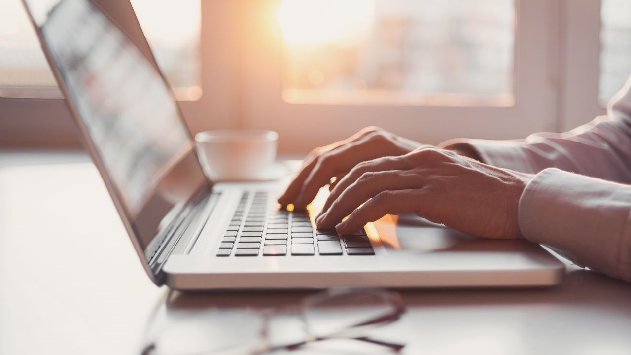 hand typing on laptop