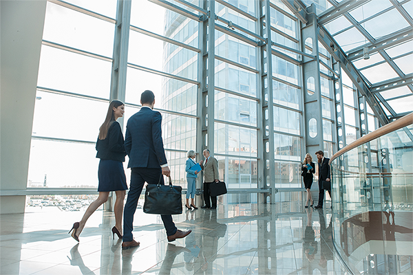 people walking in glass structure