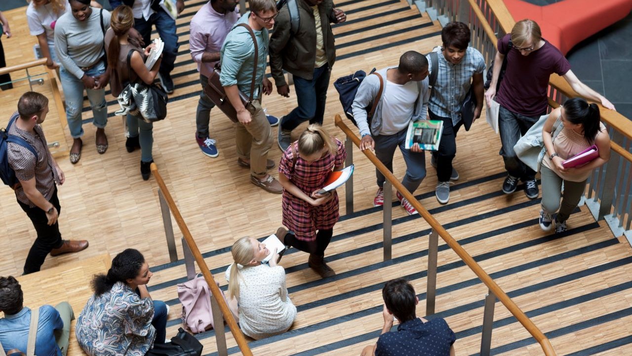 elevated view of university students walking up and down stairs