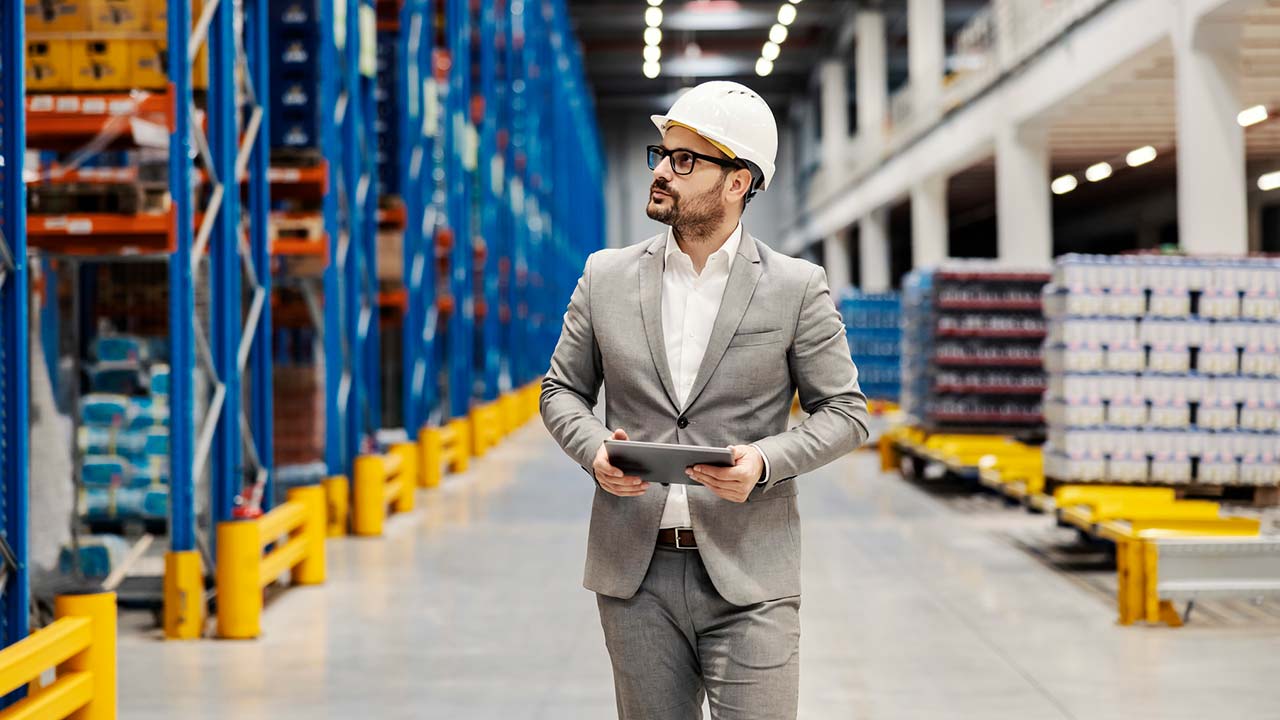 man in a factory performing a risk engineering assessment