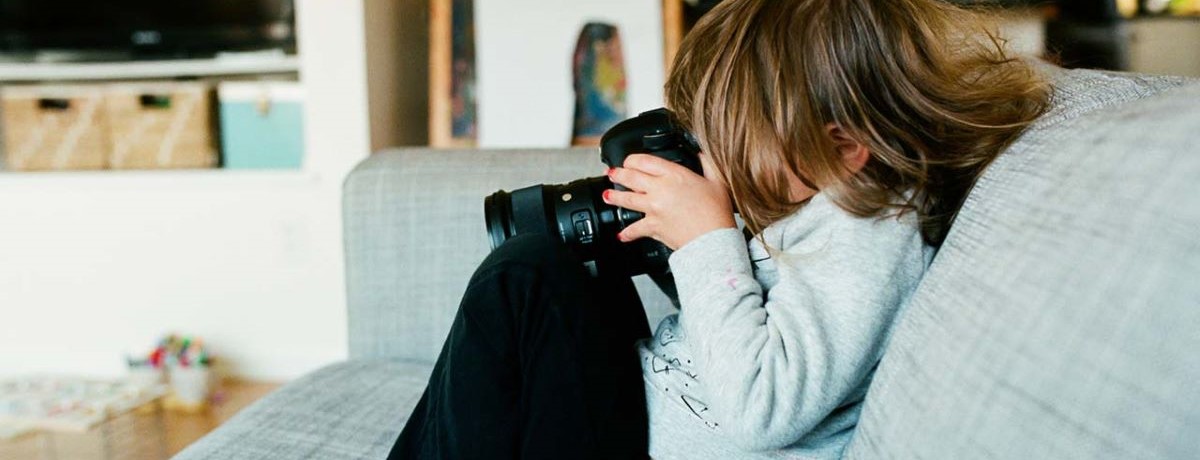 little girl with big camera