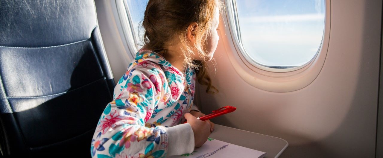 girl looking out plane window