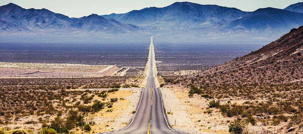 endless straight road with mountain view