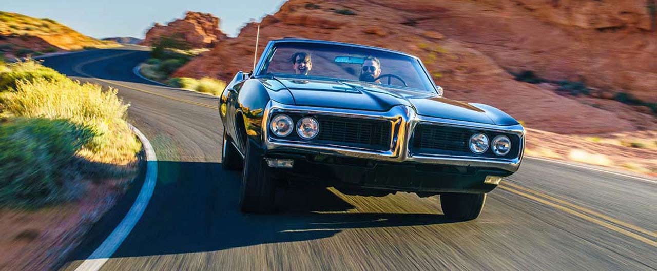 couple driving together in vintage car