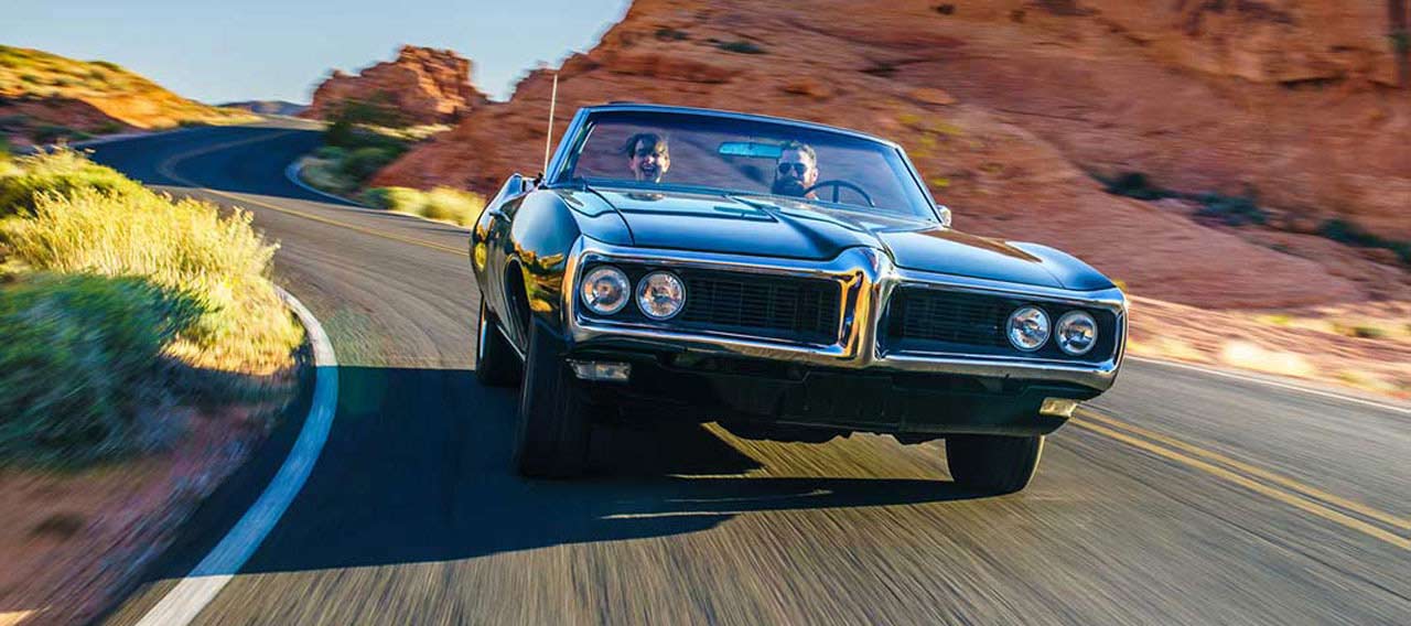 couple driving together in cool vintage car