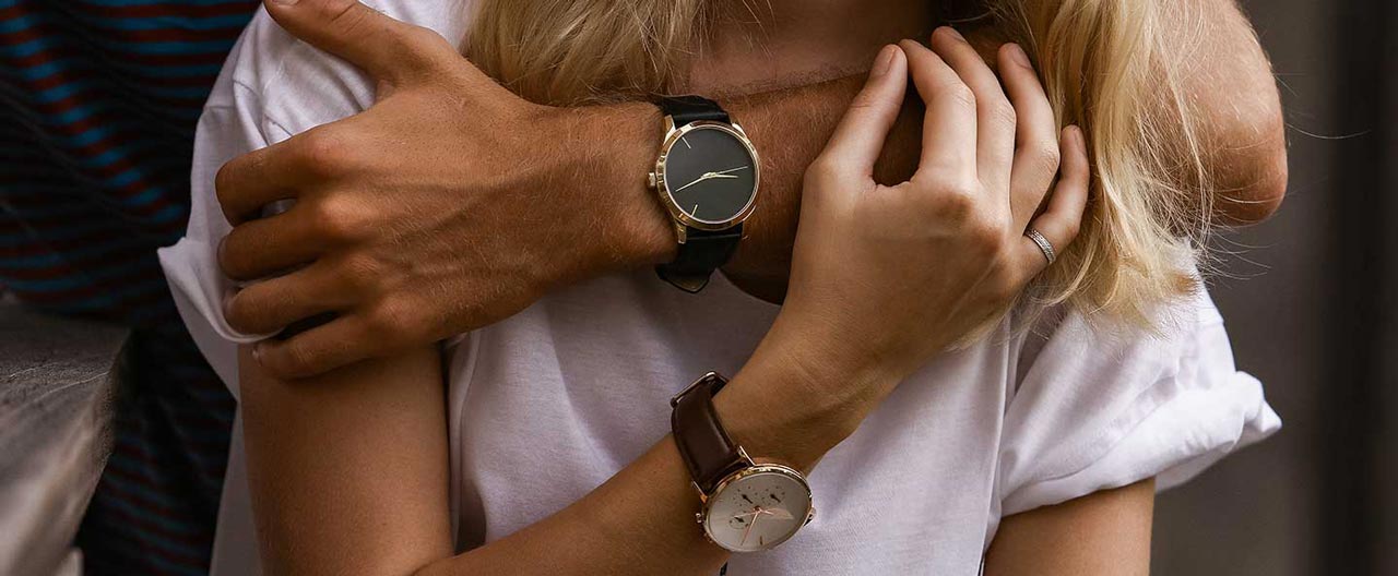 hugging couple with engagement watches